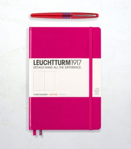 Leuchtturm 1917 in berry and a Pilot Metropolitan fountain pen in red.