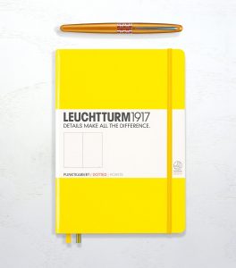 Leuchtturm 1917 in lemon yellow, dotted, and a Pilot Metropolitan in orange.